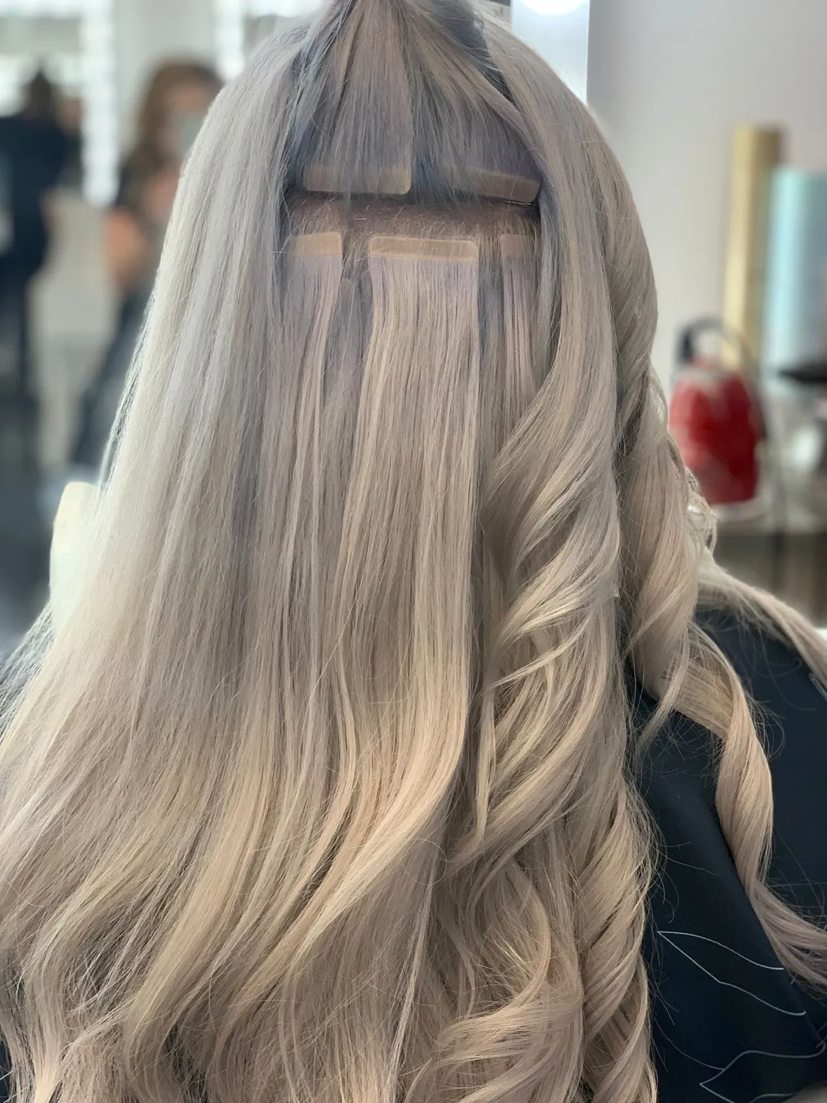 Process of Adding Professional Tape In Extensions to the Blond Hair in Louisville, KY
